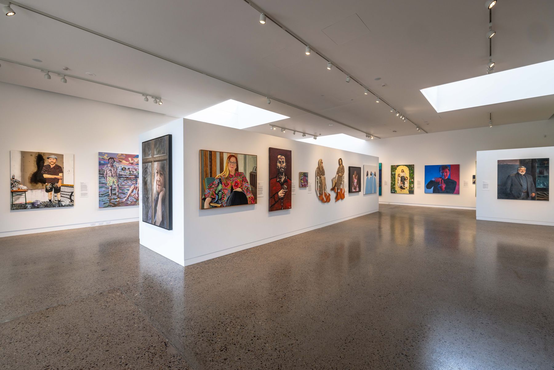 The Archibald Prize 2023 regional tour installed in a skylit gallery at SECCA