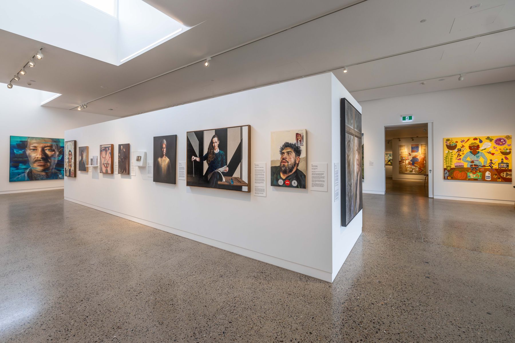A skylit gallery at SECCA hung with the Archibald Prize 2023 regional tour