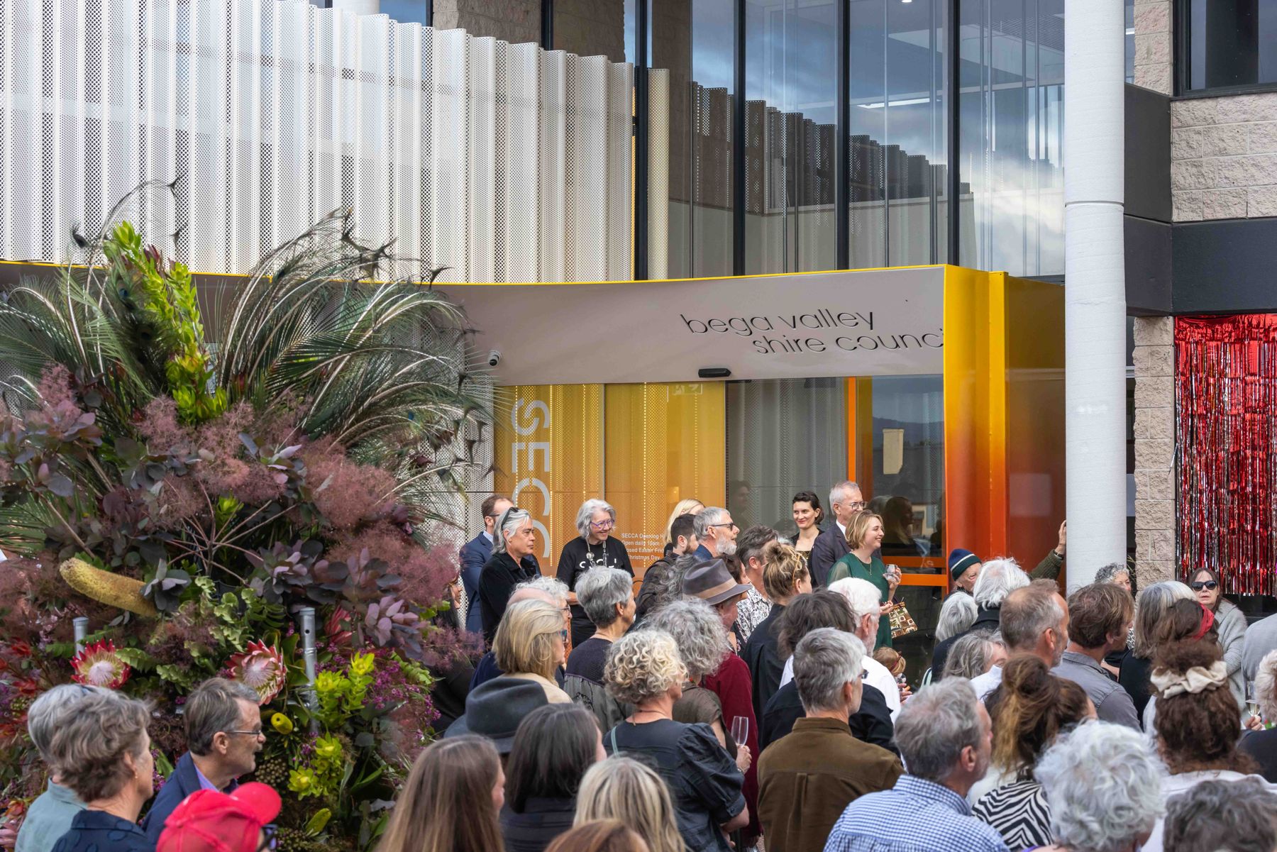 A packed courtyard crowd at the opening of the Archibald Prize 2023 regional tour at SECCA